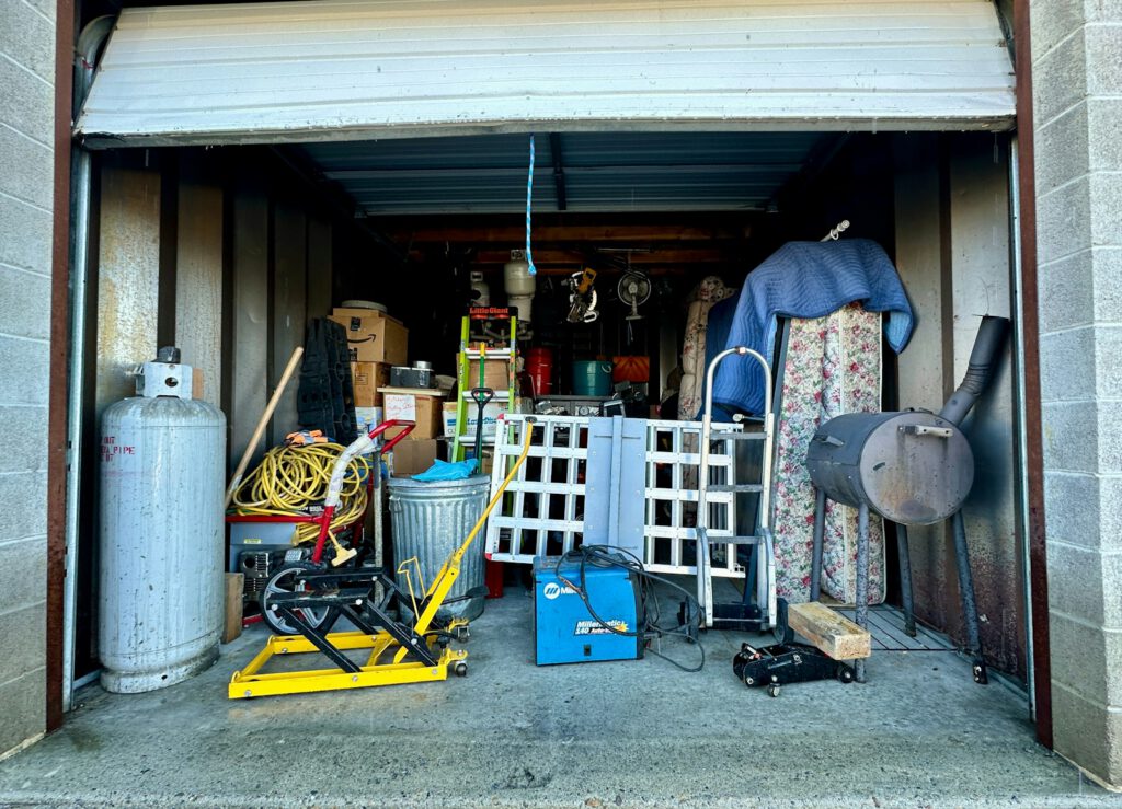 Photo by Adam Winger a garage filled with lots of clutter and tools