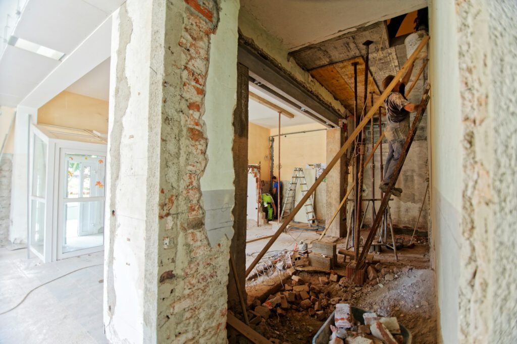 Photo by Milivoj Kuhar man climbing on ladder inside room